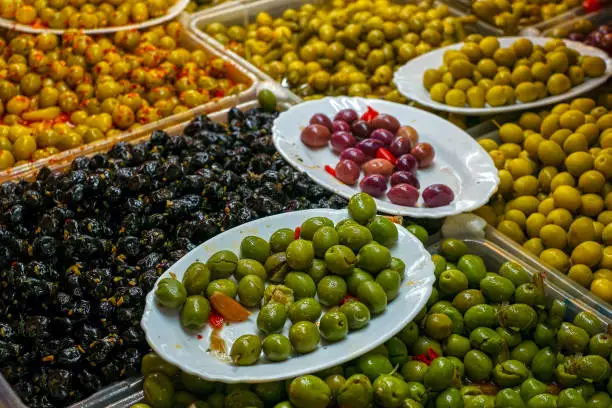 Photo of A variety of types of olives at a market stall