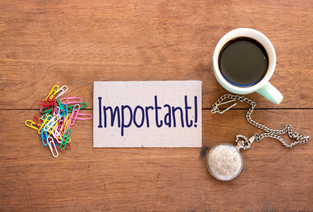 istock Important text on small paper with coffee cup on wooden table 1057459042