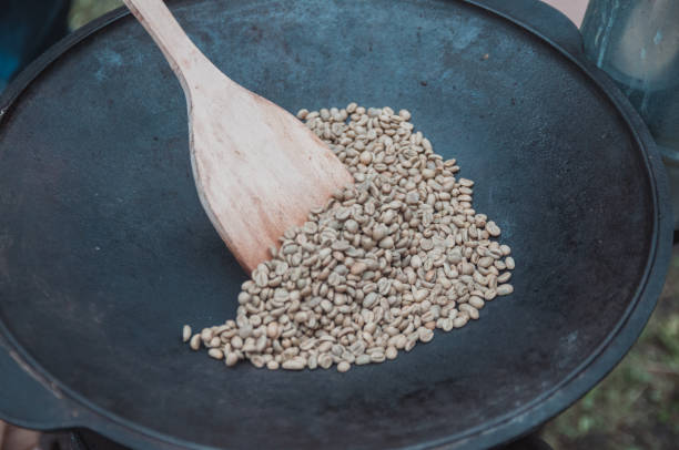 istock Traditional coffee beans roasting in metal basin with spoon 1057459370
