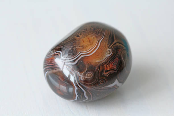 istock Agate. Natural round or oval stone agate with striped texture or pattern. A beautiful stone is agate 1057465438