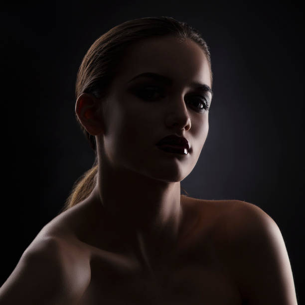 istock Beauty girl studio shot. Dark silhouette 1057465984