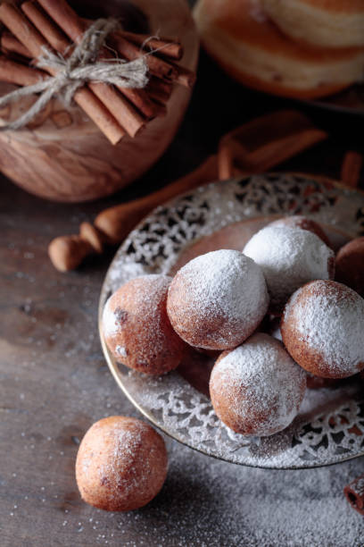 istock Sweet donuts with cinnamon sticks powdered with sugar. 1057474918