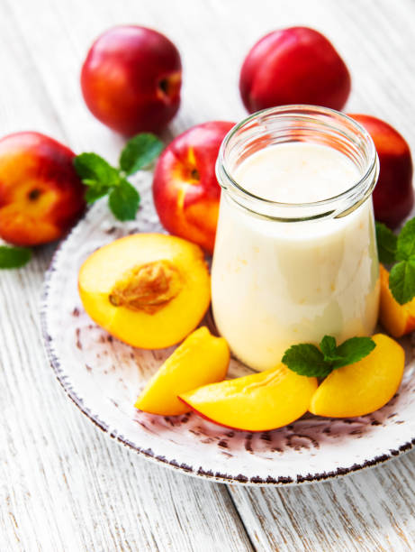 istock Yogurt with fresh nectarines on a white wooden table 1057475132
