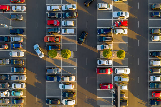istock Top down view from drone on mall parking with many cars. 1057477452
