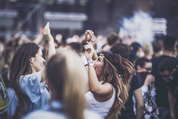 istock Young happy women having fun while dancing on a music concert. 1057478158