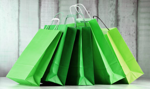 istock Composition with green paper shopping bags 1057478276