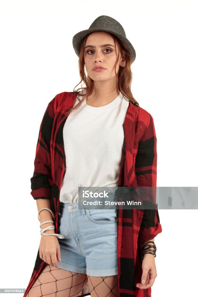 Sexy but moody grunge, rock punk girl in a long oversized white t-shirt with a blank space ready for your design Girl with long auburn, brunette hair with a grunge, punk fashion look displaying a blank t-shirt ready for your design mock-up. 1990-1999 Stock Photo