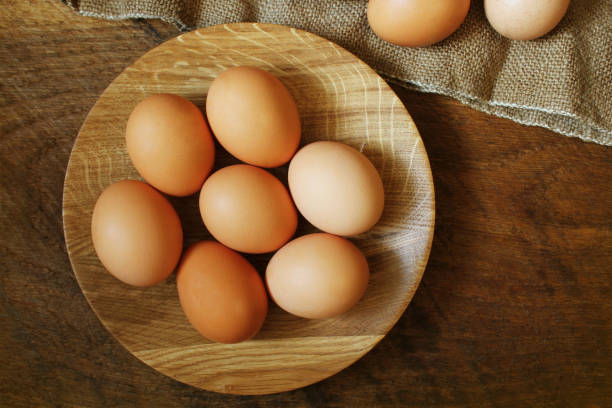 istock Easter background. Rustic wooden table with plate, egg, jute bag . Top view 1057480078