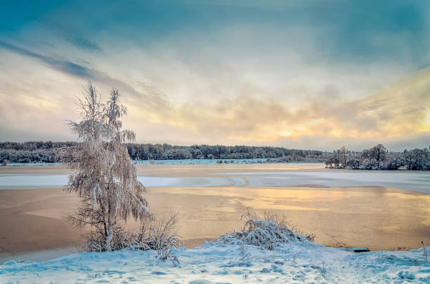 istock Winter landscape with lake and trees covered with frost 1057480762