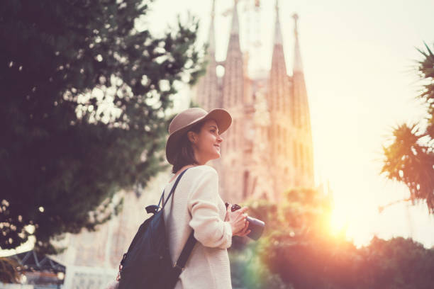 Tourist woman with camera exploring Bracelona Smiling woman enjoying Barcelona barcelona spain photos stock pictures, royalty-free photos & images