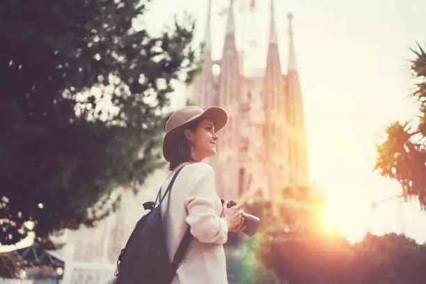 Photo of Tourist woman with camera exploring Bracelona