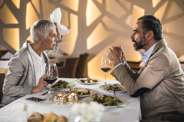 istock Frustrated mature couple arguing on a dinner in a restaurant. 1057487564