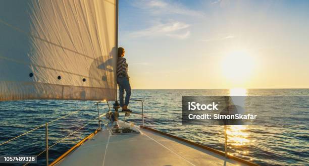 Woman Staying On Edge Of Prow Croatia Stock Photo - Download Image Now - Sailboat, Sailing, Women