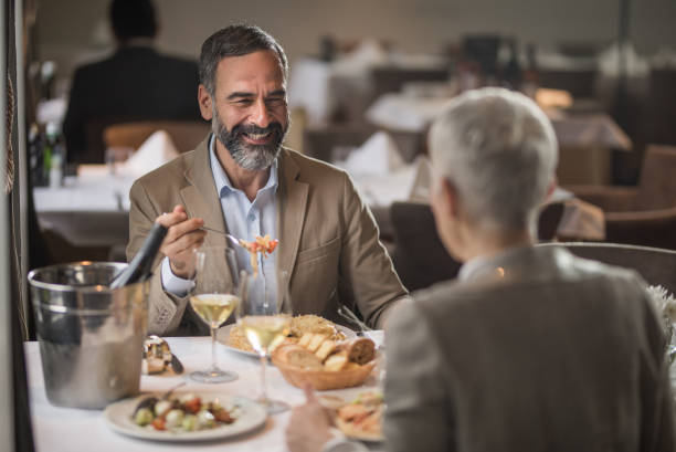 istock Happy mature couple talking during lunch time in a restaurant. 1057489414