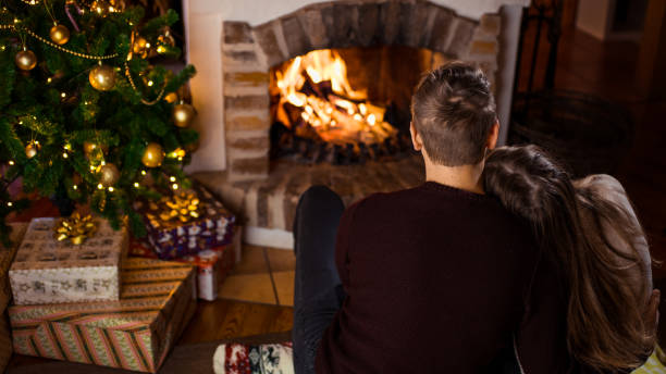 istock Couple sitting by fireplace 1057491960