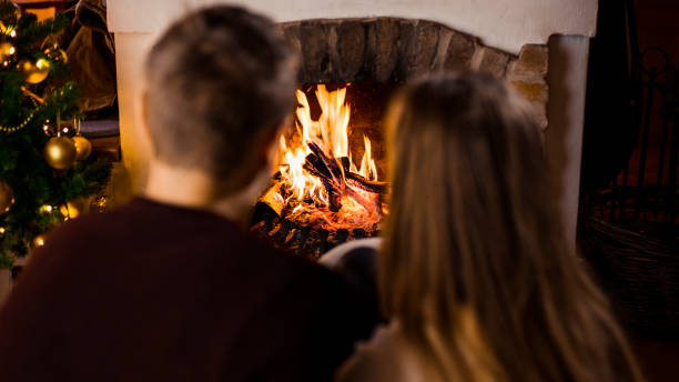 istock Couple sitting by fireplace 1057491986