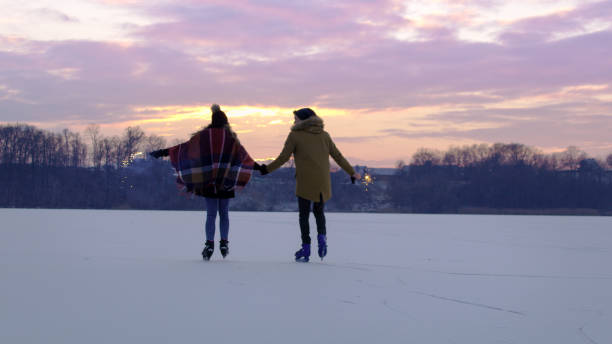 istock Couple skating on frozen lake 1057492404