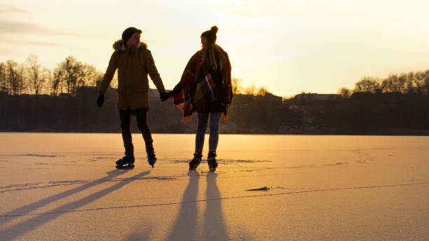istock Couple skating on frozen lake 1057492414