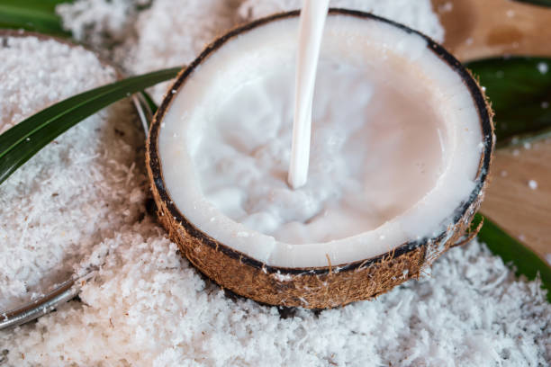 istock pouring fresh coconut milk in bowl and coconut fruit ingredient 1057495026