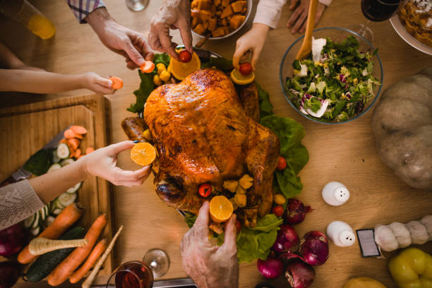 istock Above view of unrecognizable people decorating Thanksgiving turkey. 1057497824