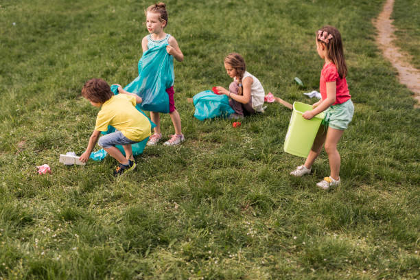 istock Group of small kids cleaning the park from garbage. 1057500534