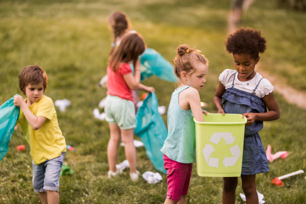 istock Children doing environmental cleanup during spring day at the park. 1057500600
