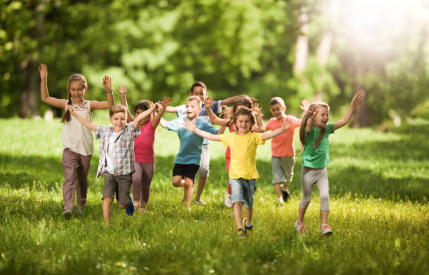istock Carefree children having fun while running in spring day at the park. 1057500790