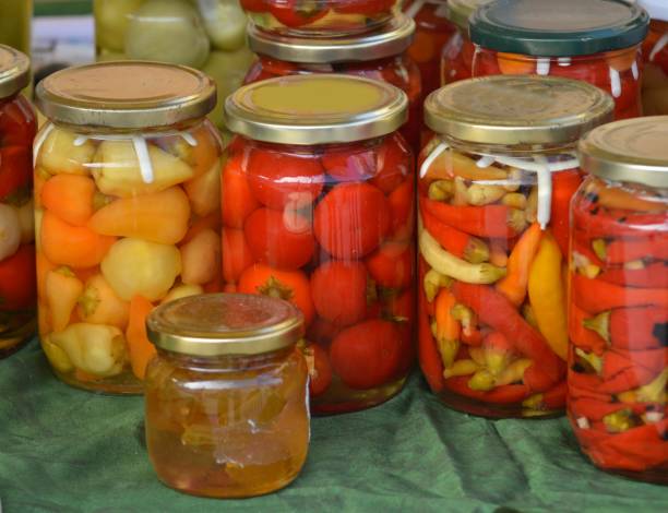 istock Jars with preserved vegetables and fruits on the market stall 1057504132