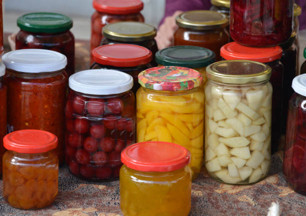 istock Jars with preserved vegetables and fruits on the market stall 1057504144