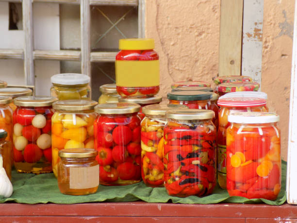 istock Jars with preserved vegetables and fruits on the market stall 1057504154
