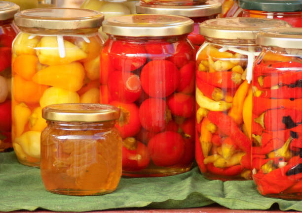 istock Jars with preserved vegetables and fruits on the market stall 1057504156