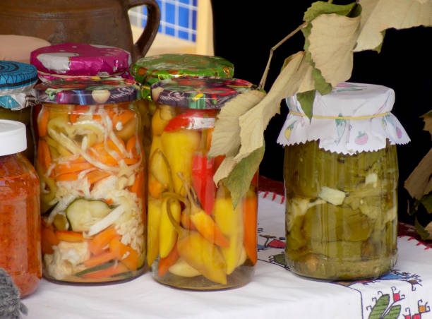 istock Jars with preserved vegetables and fruits on the market stall 1057504166