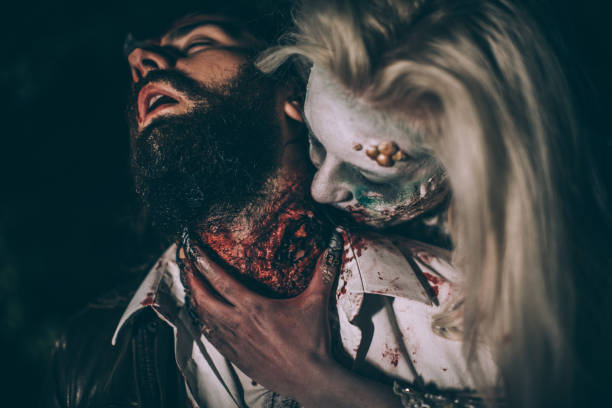 Undead woman biting man Woman dressed as witch biting man at night. Zombie concept male vampire biting his victim stock pictures, royalty-free photos & images