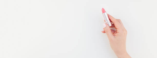 istock Woman hand with pink lipstick 1057504972