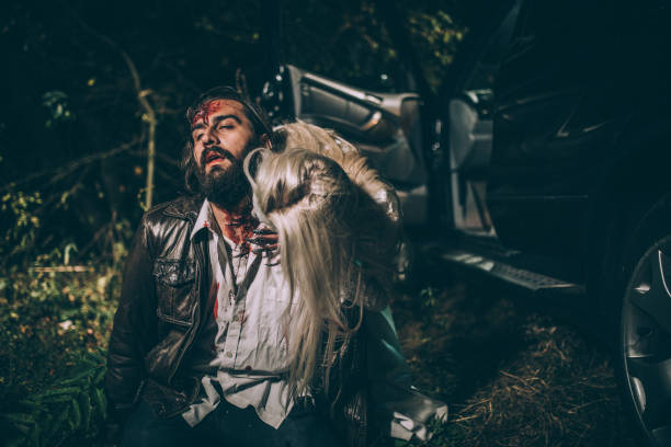 Zombie biting man Woman dressed as witch biting man at night. Zombie concept male vampire biting his victim stock pictures, royalty-free photos & images