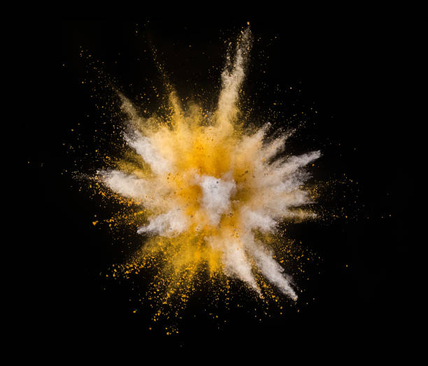 istock Explosion of yellow powder on black background 1057507044