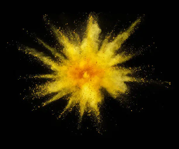 Explosion of yellow powder isolated on black background. Abstract colored background
