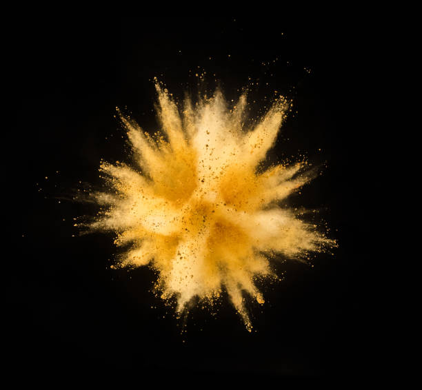 istock Explosion of yellow powder on black background 1057507058
