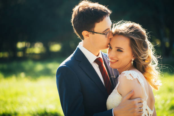 istock bride and groom embracing on nature background 1057508434