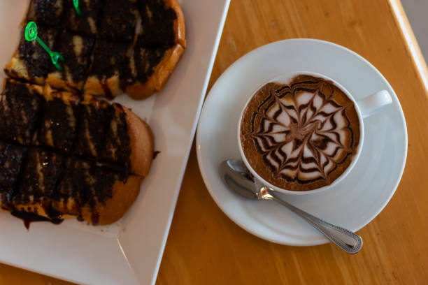 istock Coffee in a cup and bread with chocolate 1057508978