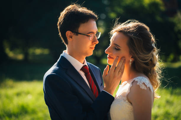 istock bride and groom embracing on nature background 1057509220