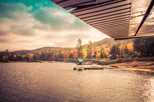 Seaplane docked at the shore in Long Lake, NY, awaiting leaf-peepers and adventure seekers, retro split tone