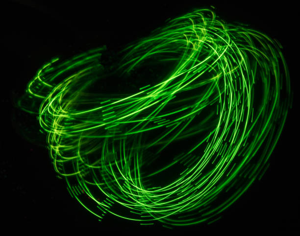 istock Overlaying wavy lines forming an abstract pattern on a dark background. Long exposure light background. 1057517126