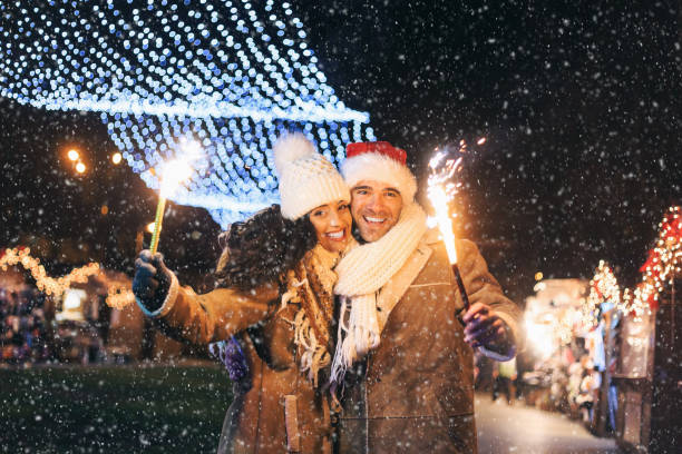 istock Young couple having fun with sparkling candles at night 1057519246