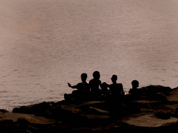 istock a group of people sitting on the rocks 1057521652