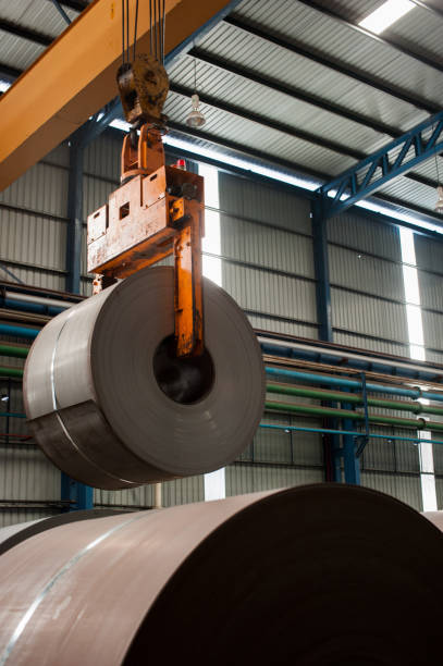 istock Crane loading of metal steel rolls 1057521942