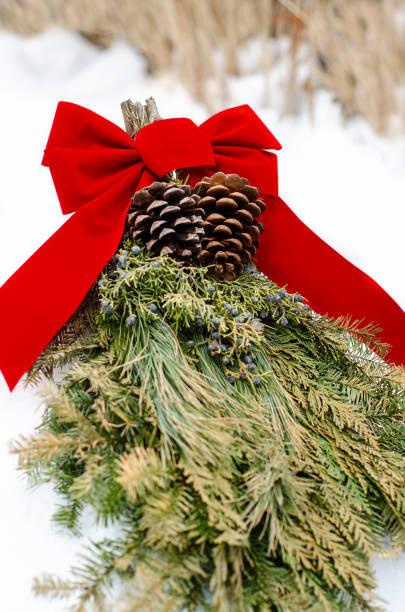 istock Holiday Evergreen Door Swag with Red Bow 1057523530