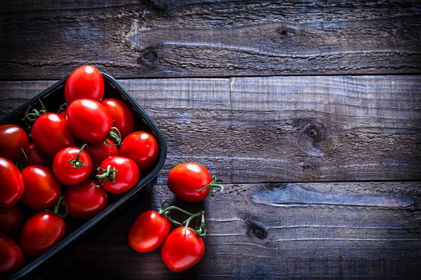 istock Fresh ripe tomatoes in a plastic container still life 1057523890