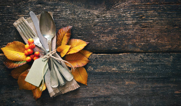 istock Autumn background with vintage place setting on old wooden table 1057528852