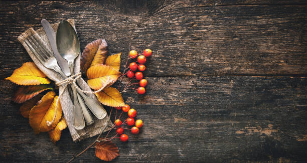 istock Autumn background with vintage place setting on old wooden table 1057528858